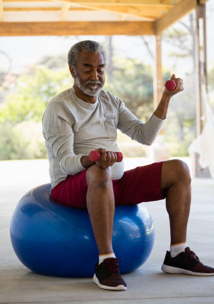 senior man exercising with dumbbells on exercise b QHF7KAE 1